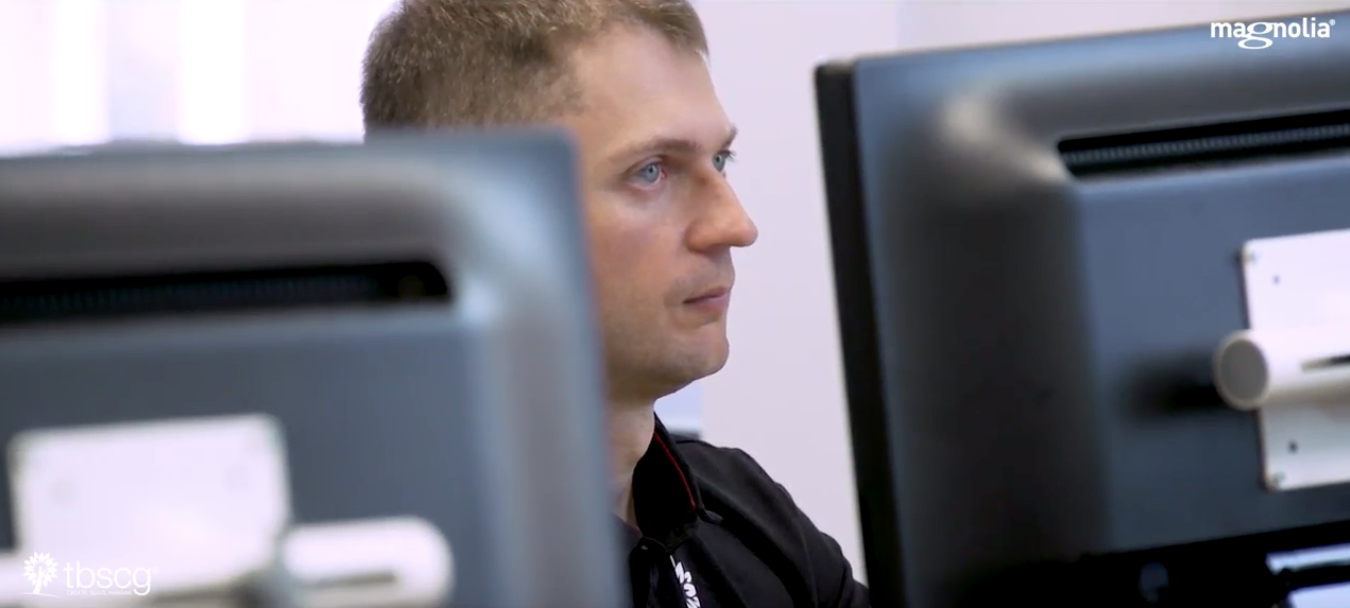 Man staring at two computer screens